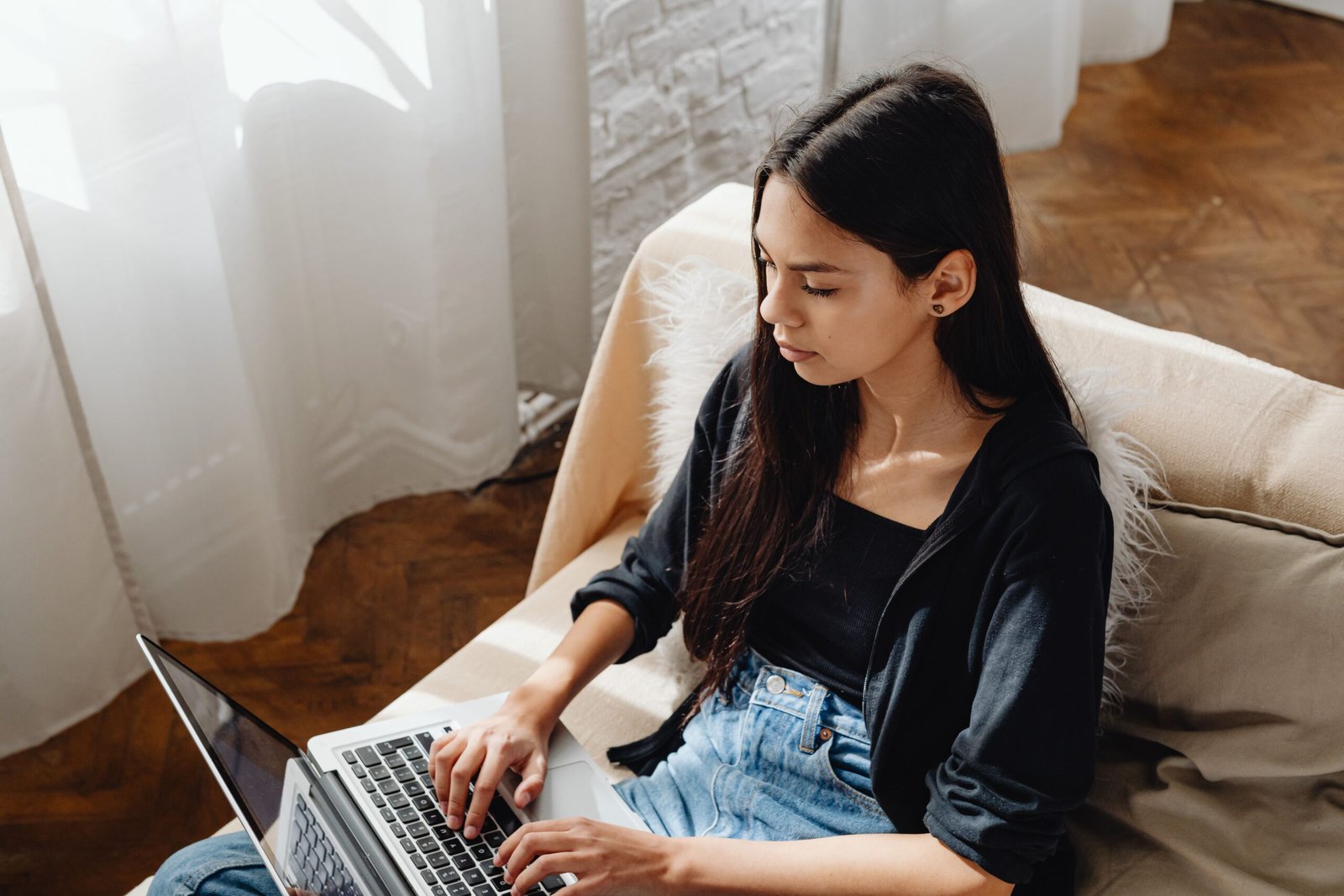 Woman focused on work using a laptop at home