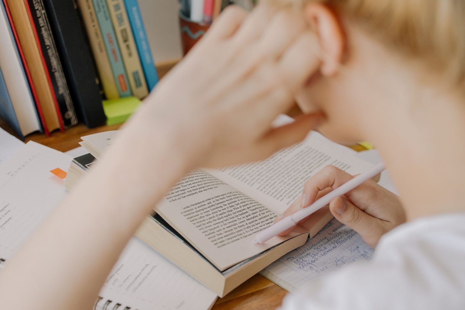 Student studying with an open textbook preparing for the SPSC exam