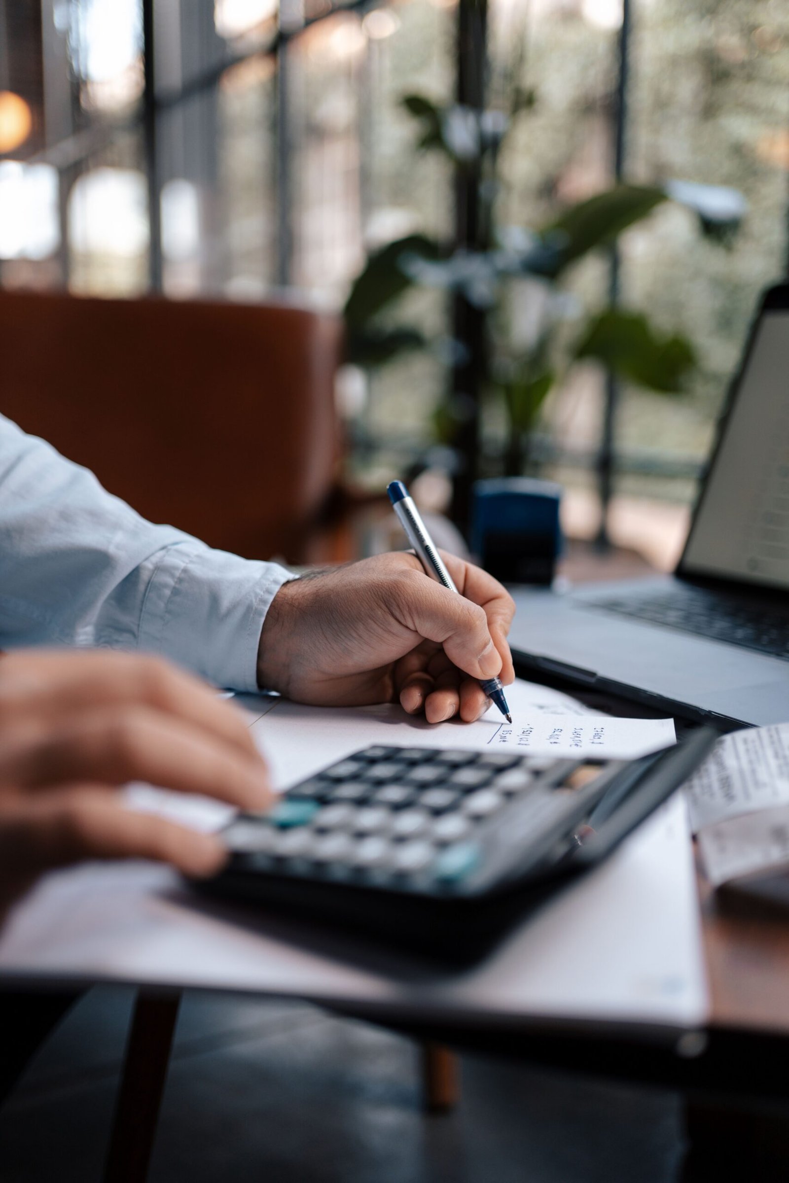 Freelancer calculating taxes with calculator for FBR filing in Pakistan