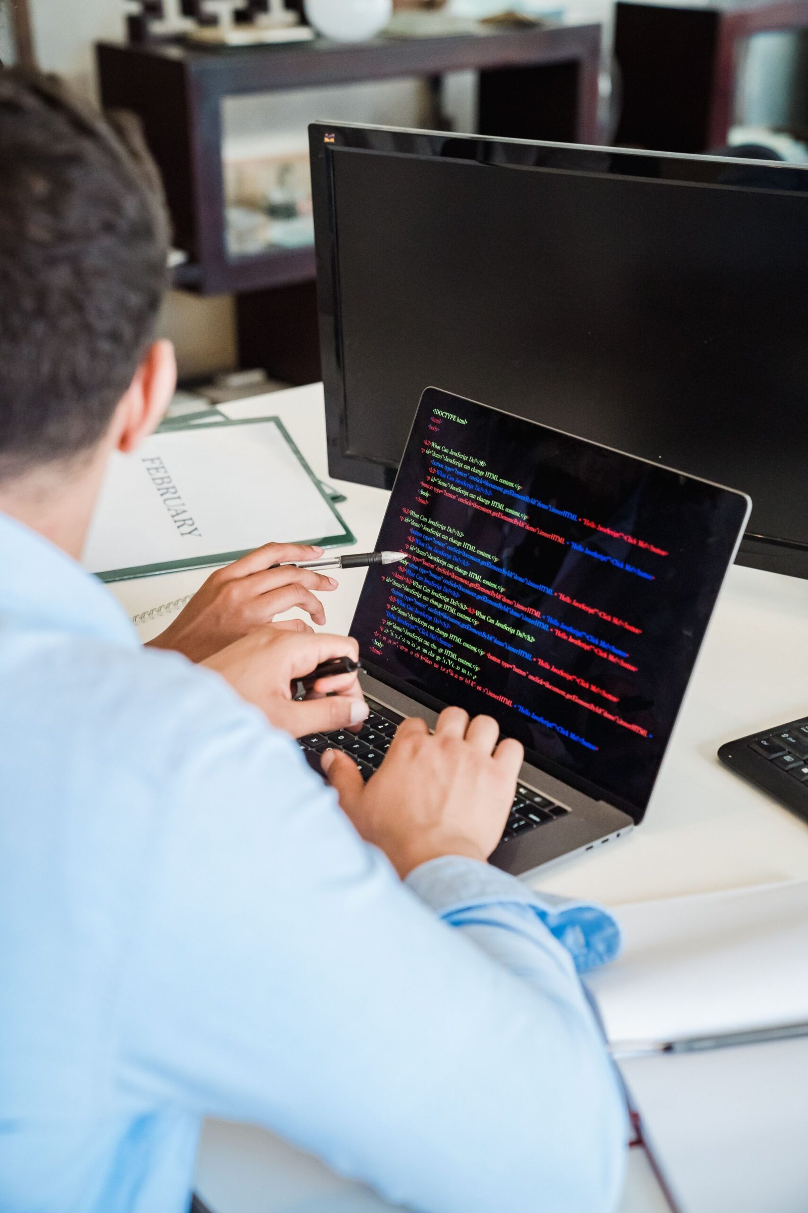 Programmer typing code on a laptop, representing a web development career in Pakistan