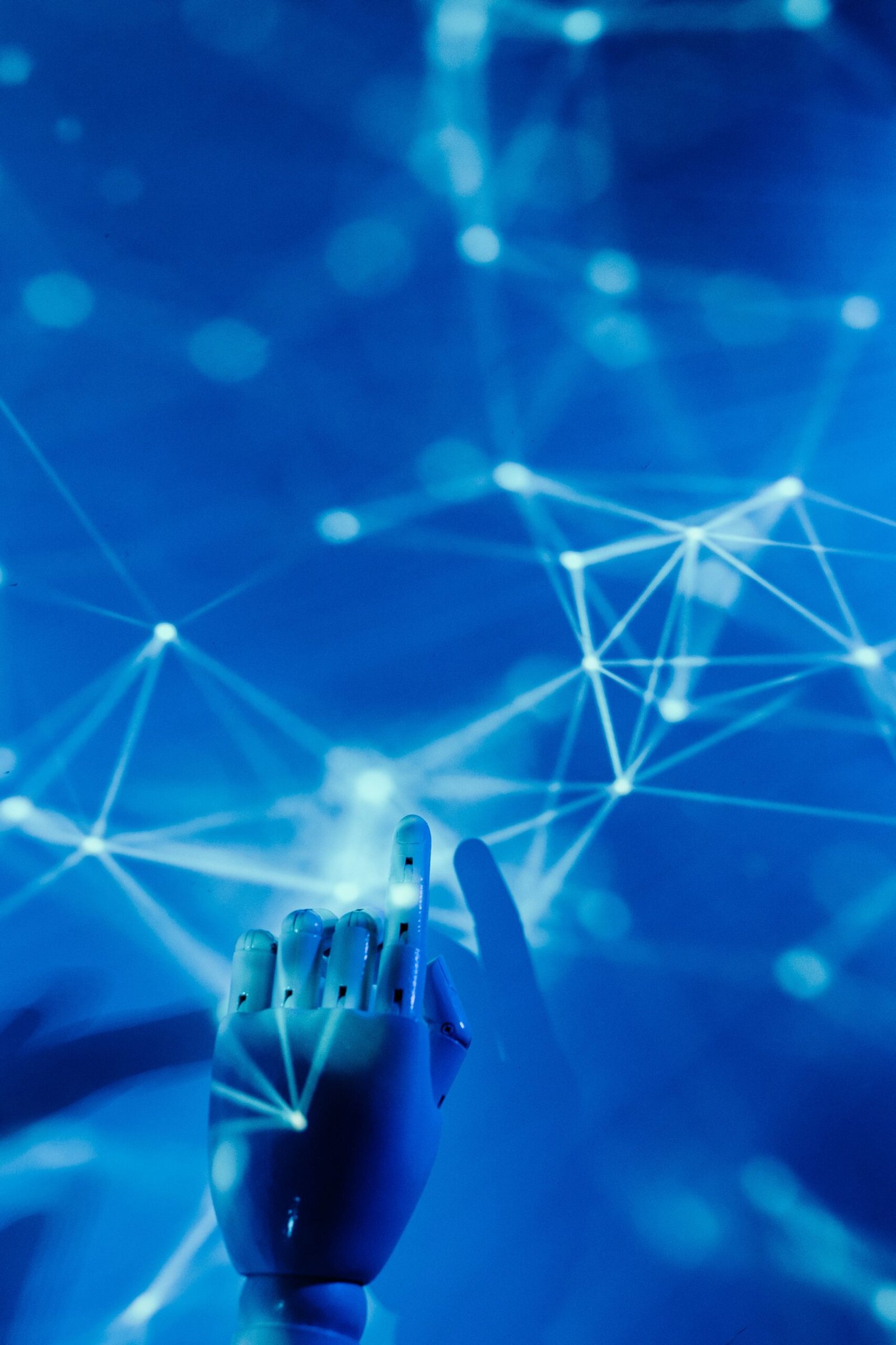 Futuristic robotic hand touching a digital network on a blue background, representing AI jobs in Pakistan