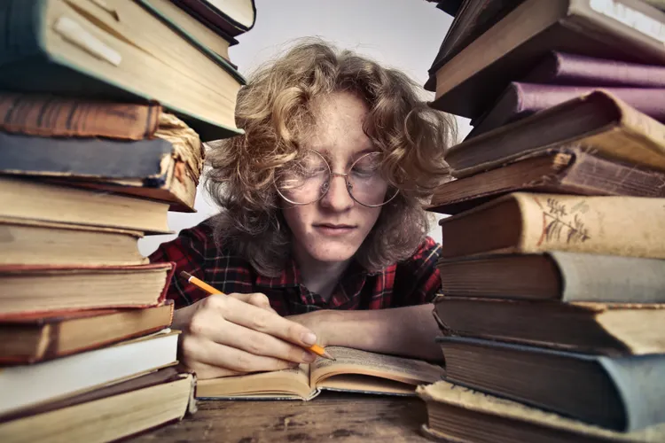 Student preparing for CSS exam in Pakistan with books and notes