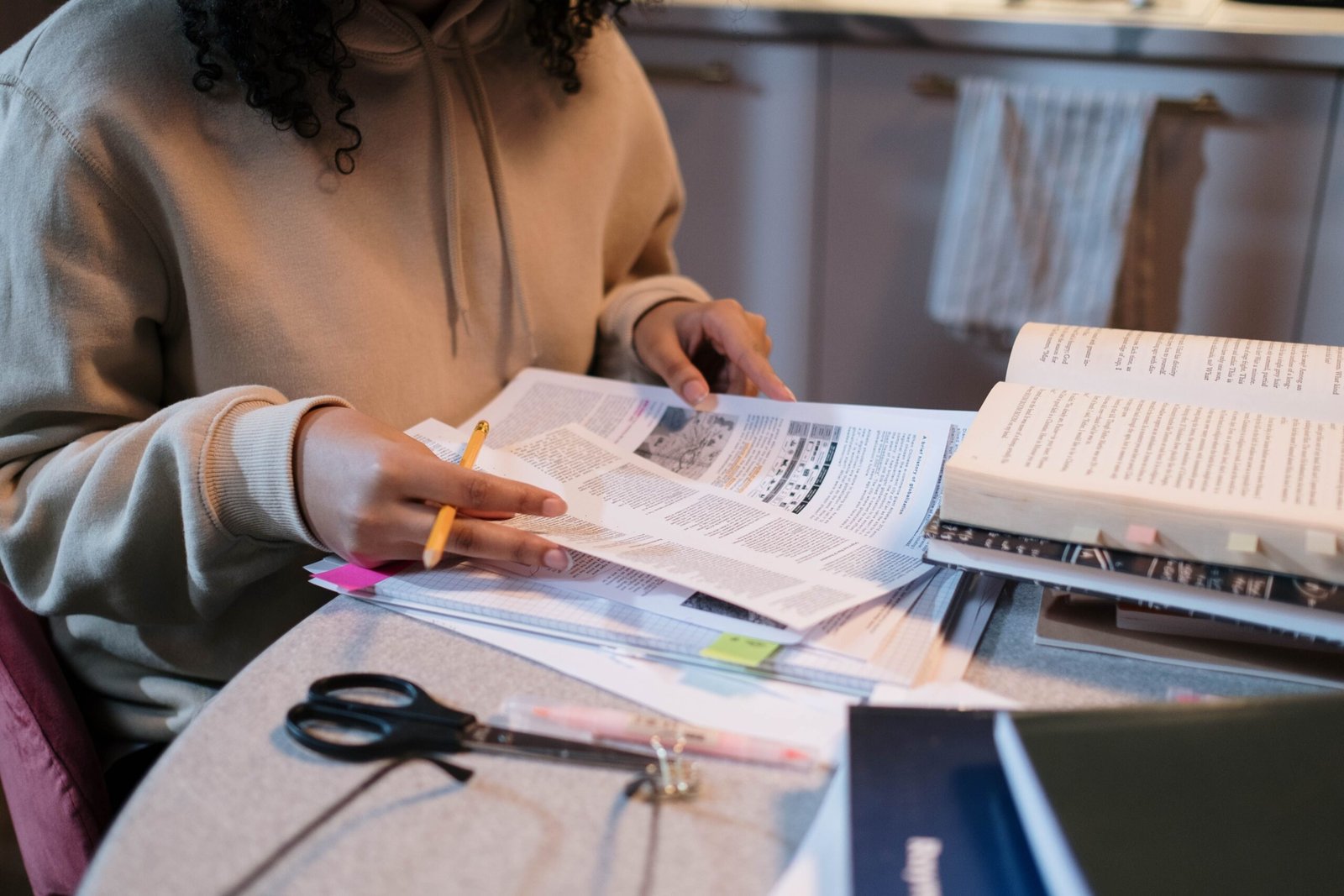 Student preparing for the KPPSC exam with books and notes