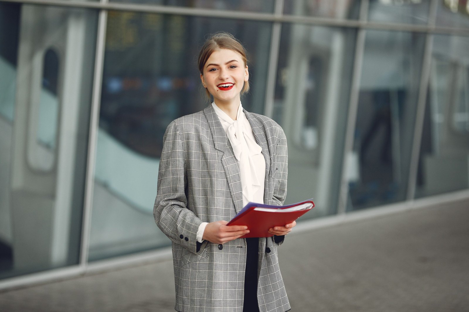 Smiling young professional woman holding documents, ready for a job after matric in Pakistan